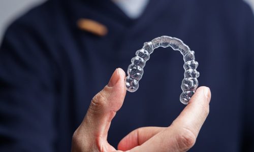 Un dentiste montre une gouttière transparente Invisalign